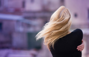 Girl hugging herself in wind